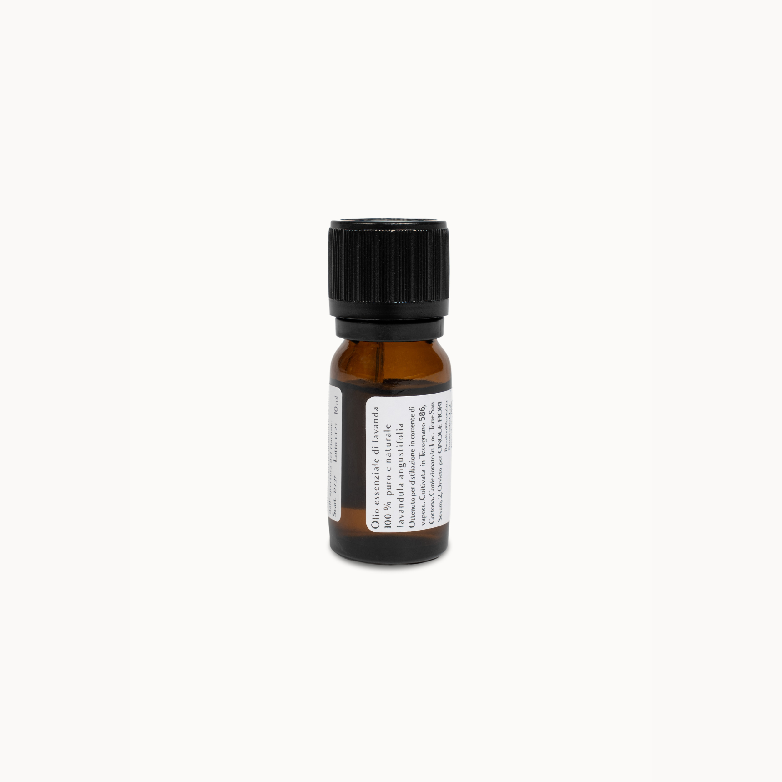 A small amber glass bottle with a black ribbed cap and a white label, photographed against a plain off-white background.