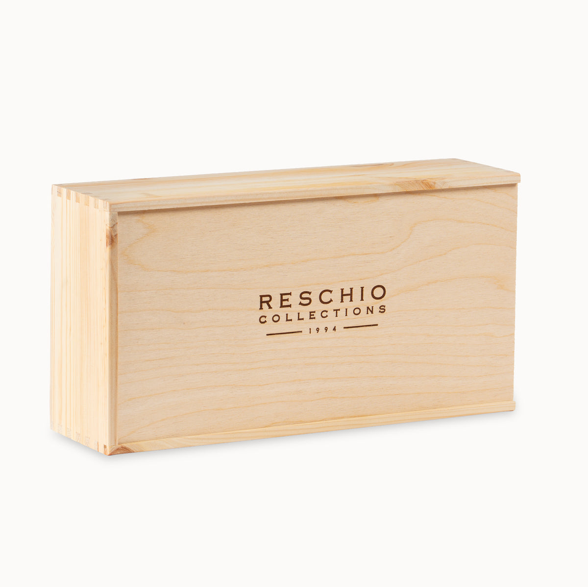 A rectangular light natural wood presentation box with 'RESCHIO COLLECTIONS 1934' engraved on the front, shown on a clean white background.